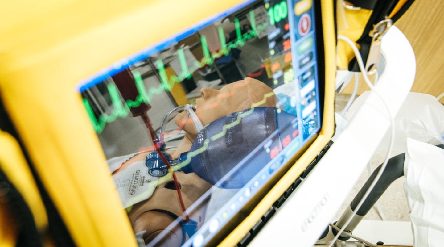 EKG monitor with a simulated manikin being reflected in the image